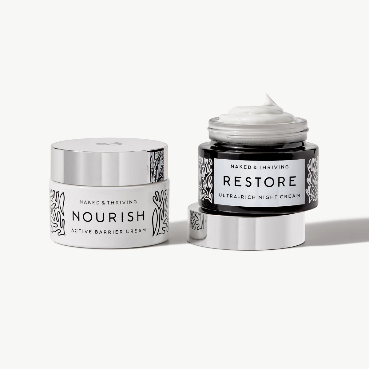 Naked & Thriving Advanced Moisturizer Duo with Nourish Active Barrier Cream and Restore Ultra-Rich Night Cream in glass, botanical-patterned jars
